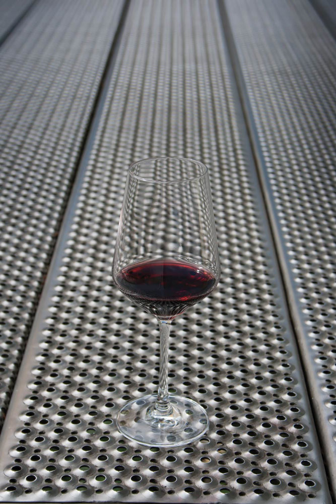 Glass of wine on a metal surface