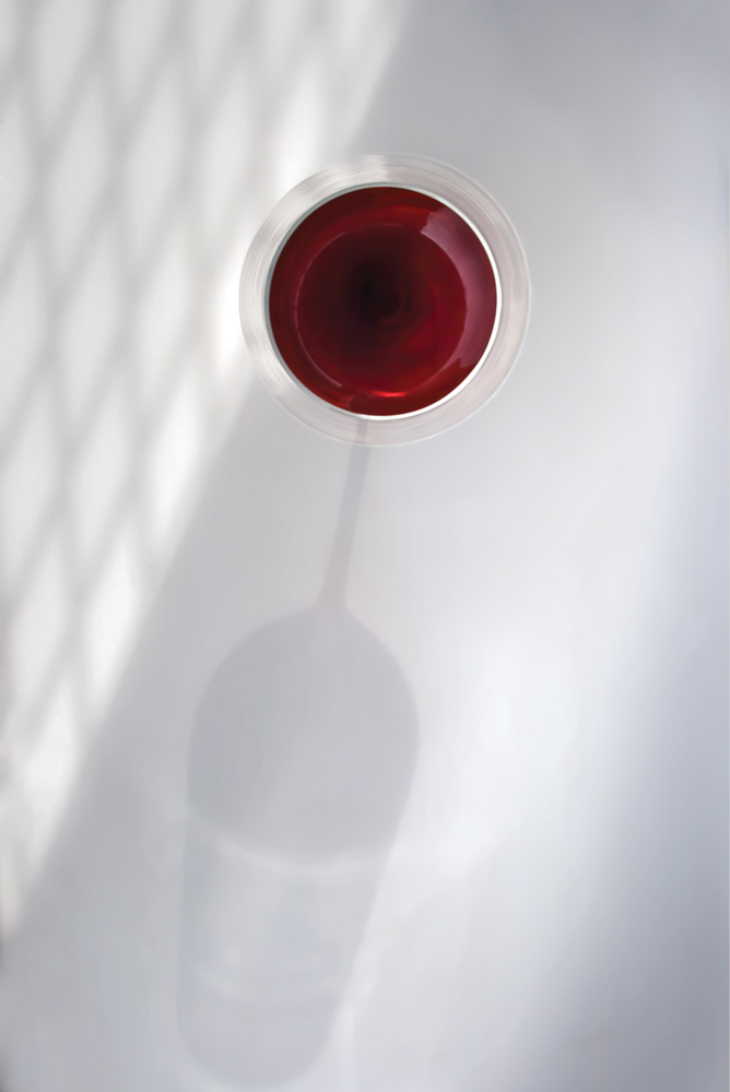 Red wine glass with a shadow